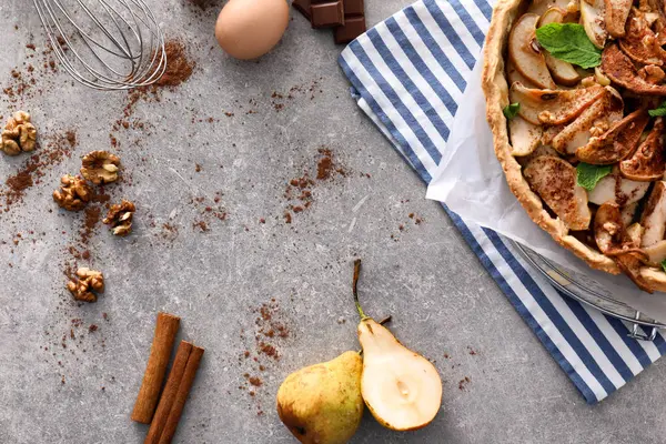 Delicious pear cake with products on grey table — Stock Photo, Image