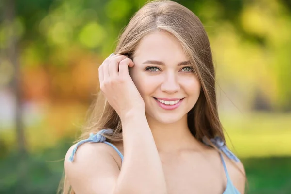 Beautiful young woman resting outdoors — Stock Photo, Image