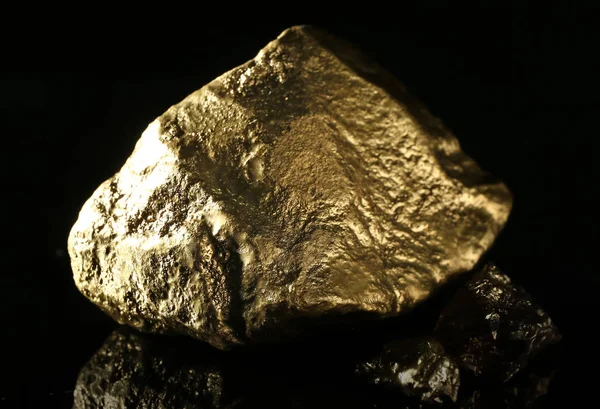 Gold nuggets on black background