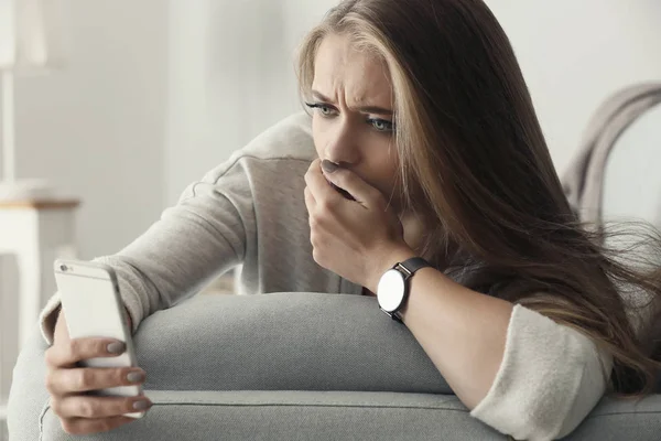 Lonely worried woman with mobile phone at home — Stock Photo, Image