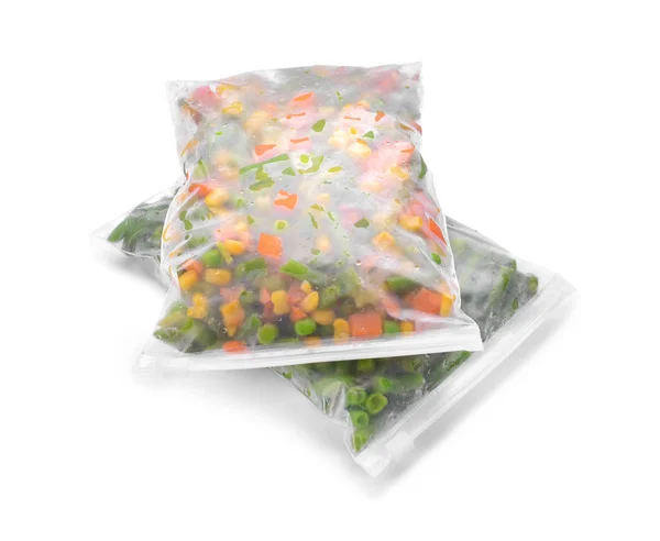 Plastic bags with frozen vegetables on white background — Stock Photo, Image