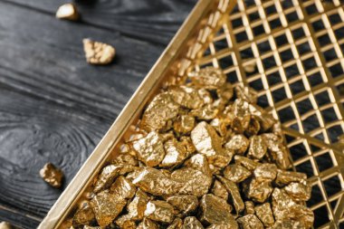 Koyu ahşap arka plan, closeup üzerinde altın nuggets ile tepsi