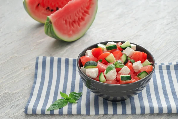 Bowl with delicious watermelon salad on light table — Stock Photo, Image