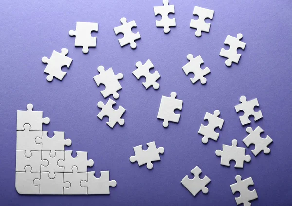 Incomplete jigsaw puzzle on color background — Stock Photo, Image