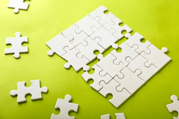 Incomplete jigsaw puzzle on color background — Stock Photo, Image