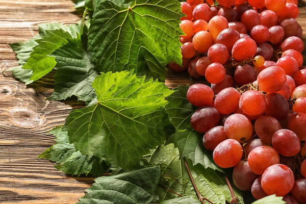 Ahşap masa üzerinde kırmızı olgun üzüm
