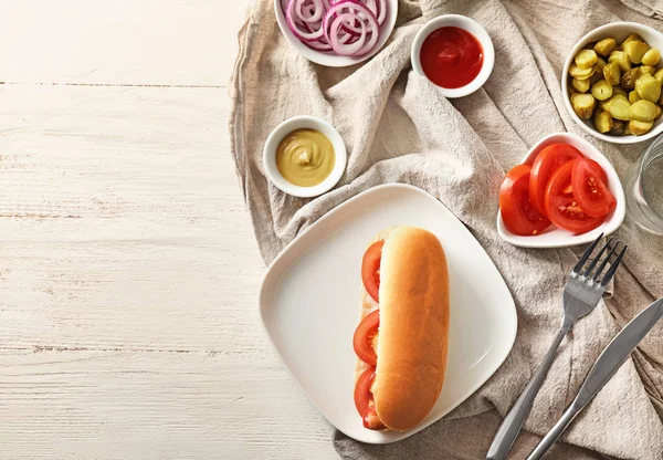 Lezzetli sosisli sandviç ve sebze beyaz tablo ile plaka