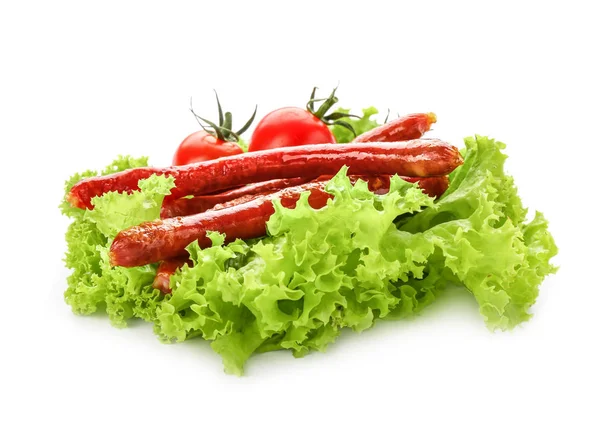 Delicious grilled sausages with tomatoes and lettuce on white background — Stock Photo, Image