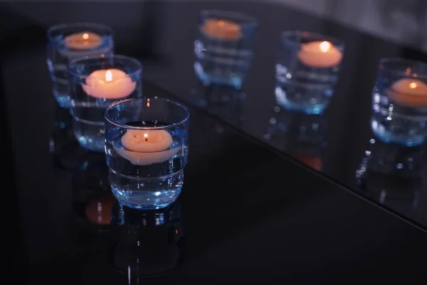 Beautiful burning candles on dark table — Stock Photo, Image