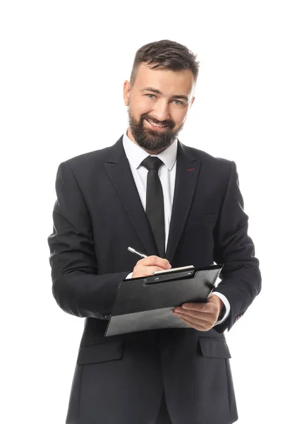 Happy businessman writing on clipboard against white background — Stock Photo, Image