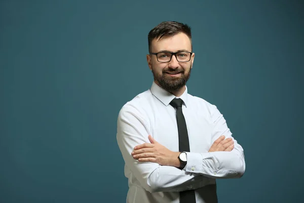 Smiling businessman on color background — Stock Photo, Image