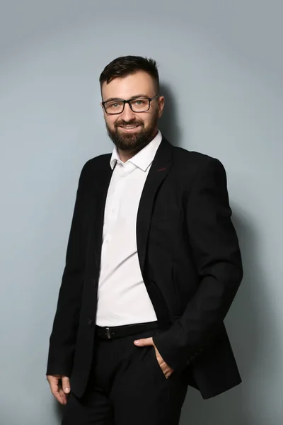 Confident businessman on grey background — Stock Photo, Image