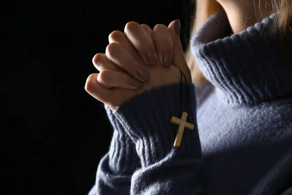 Eller üzerinde koyu arka plan, closeup dua eden genç kadın — Stok fotoğraf