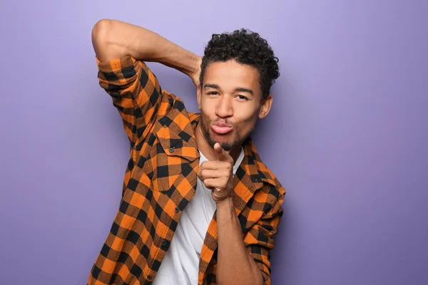 Portrait of seductive African-American man on color background — Stock Photo, Image