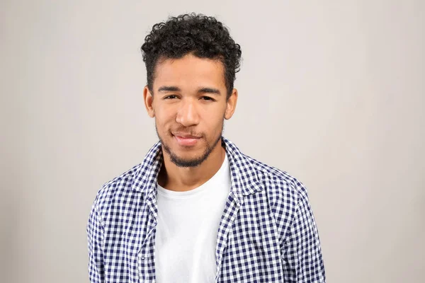 Portrait of handsome African-American man on light background — Stock Photo, Image