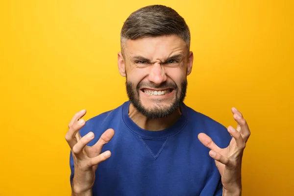 Portrait of aggressive man on color background — Stock Photo, Image