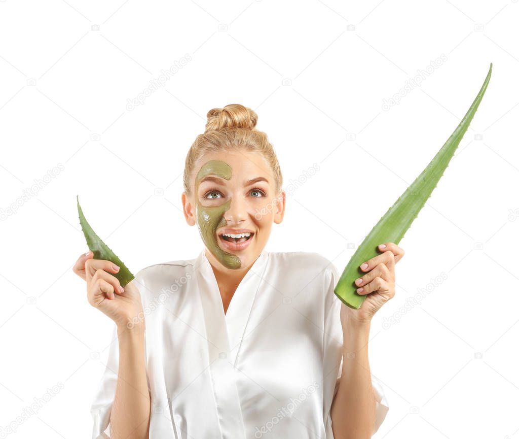 Beautiful young woman with facial mask containing aloe vera extract, on white background