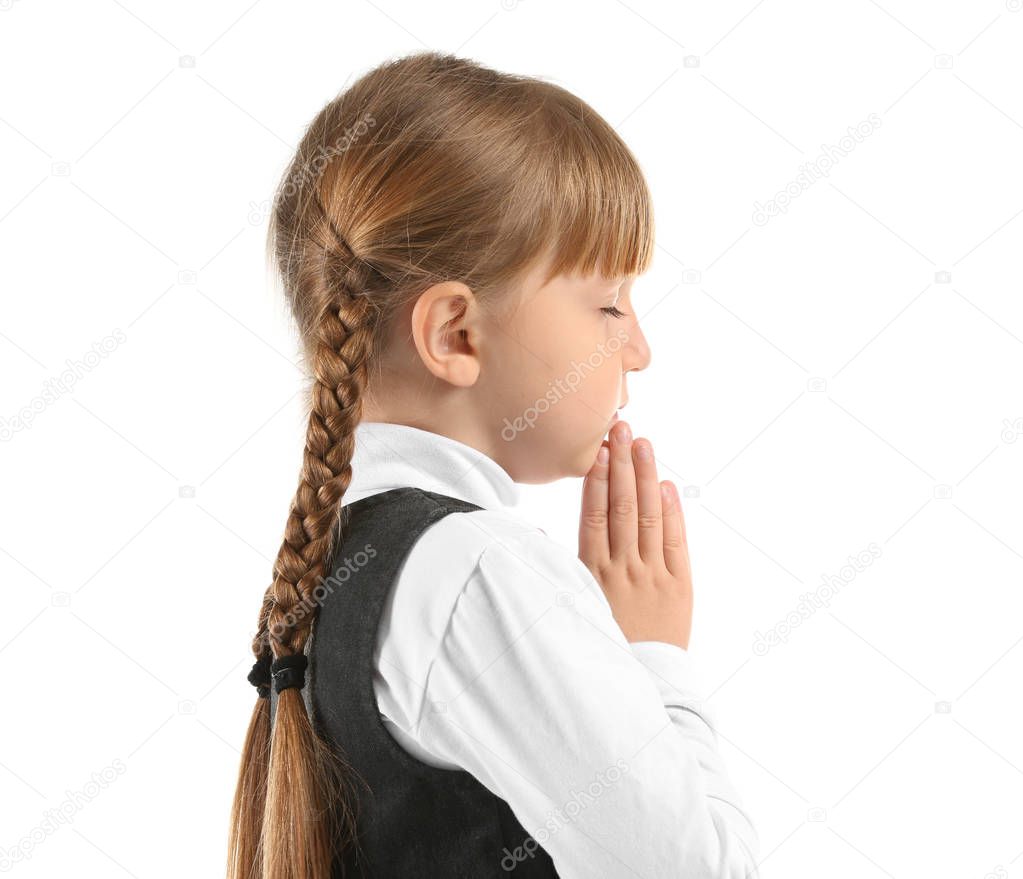 Little girl praying on white background