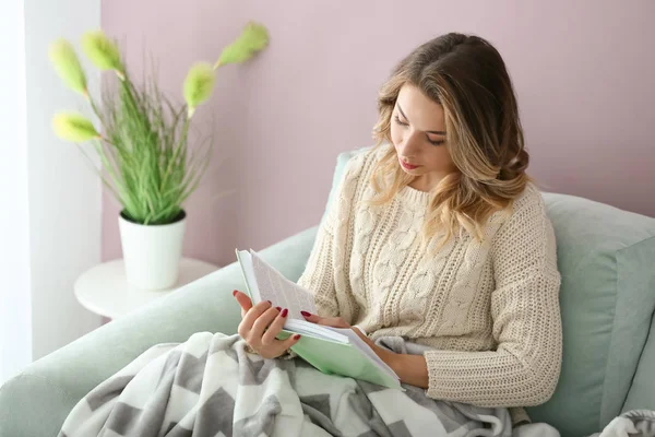 Portrait of beautiful young woman reading book at home — Stock Photo, Image