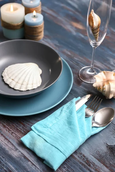 Beautiful table setting with sea shells on wooden background — Stock Photo, Image