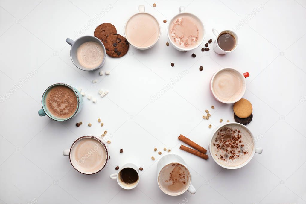 Many cups with tasty aromatic coffee on white background, flat lay