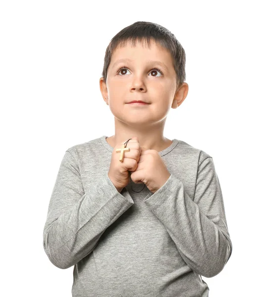 Little boy with cross praying on white background — Stock Photo, Image