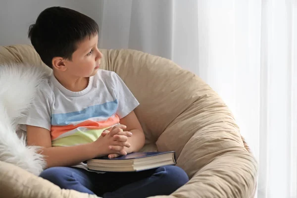 Little boy with Bible at home — Stock Photo, Image