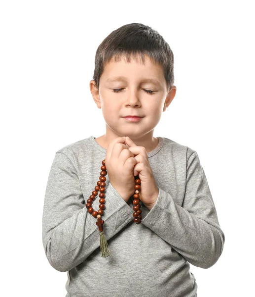 Little boy with beads praying on white background — Stock Photo, Image