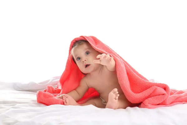 Cute little baby with soft towel on bed against white background — Stock Photo, Image