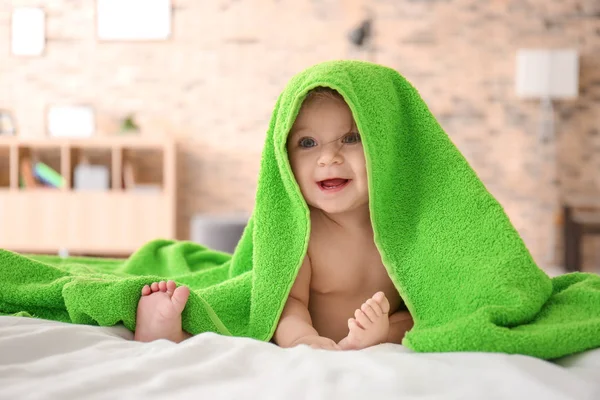 Cute little baby with soft towel on bed at home — Stock Photo, Image