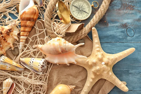 Composition with different sea shells on color wooden background — Stock Photo, Image