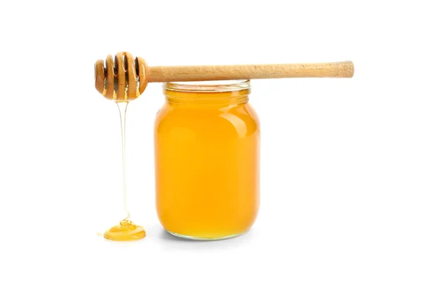 Jar of honey with dipper on white background — Stok Foto