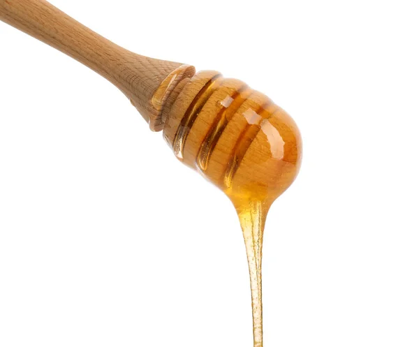 Miel goteando del cazo sobre fondo blanco —  Fotos de Stock