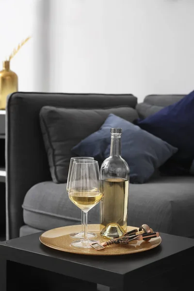 Bottle and glasses of champagne on table in modern room — Stock Photo, Image