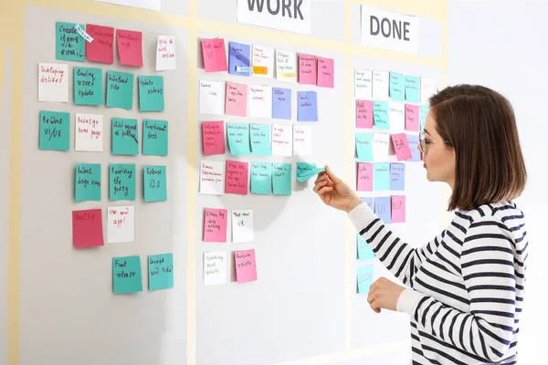 Young woman near scrum task board in office — Stock Photo, Image