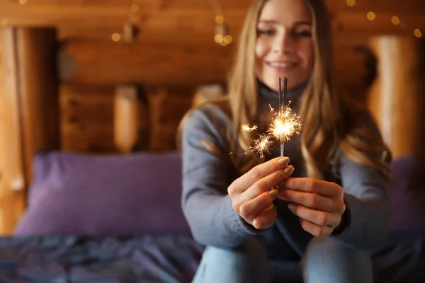 Young woman with sparklers at home — Stock Photo, Image