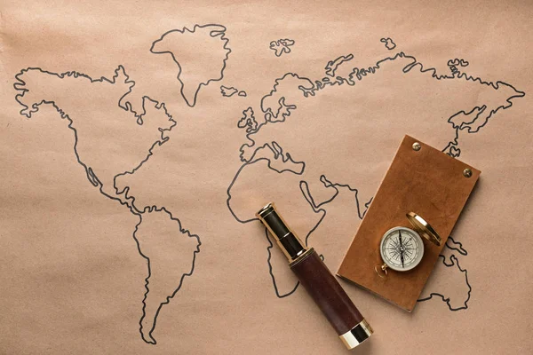 Spyglass, compass and notebook on world map. Travel concept — Stock Photo, Image