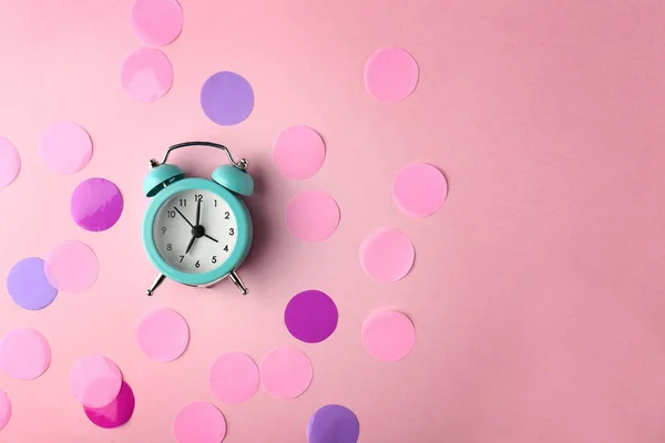 Alarm clock and circles on color background