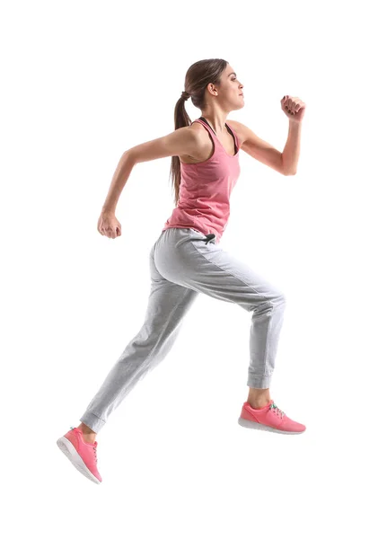 Sporty young woman running against white background — Stock Photo, Image
