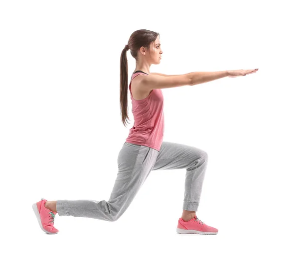 Sporty young woman training against white background — Stock Photo, Image