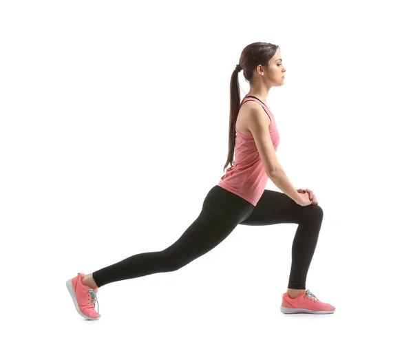 Sporty young woman training against white background — Stock Photo, Image