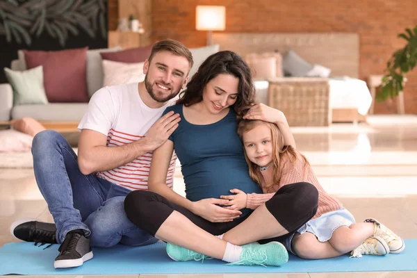 Portrait of happy family expecting baby