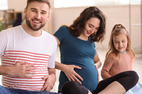 Porträt einer glücklichen Familie, die ein Baby erwartet — Stockfoto