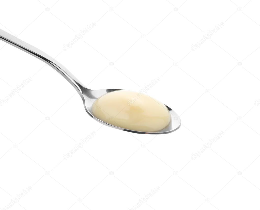 Spoon with tasty yogurt on white background