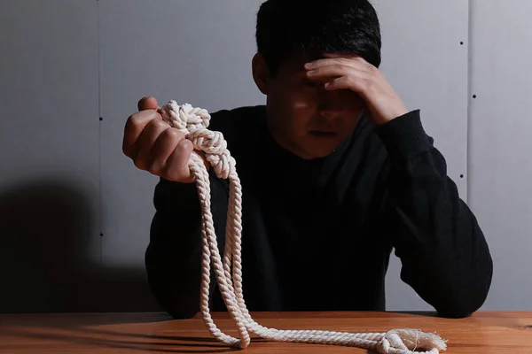 Depressed man with rope thinking about suicide at home — Stock Photo, Image