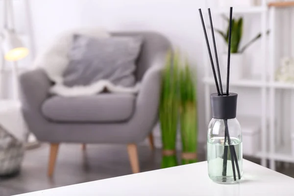 Reed diffuser on table in room — Stock Photo, Image