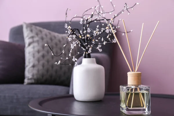 Reed diffuser on table in room — Stock Photo, Image