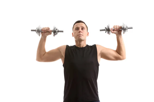 Sportlicher junger Mann beim Training mit Kurzhanteln vor weißem Hintergrund — Stockfoto