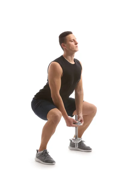 Sporty young man training with dumbbell against white background — Stock Photo, Image