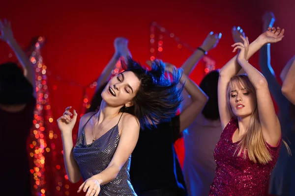 Beautiful young women dancing in night club — Stock Photo, Image